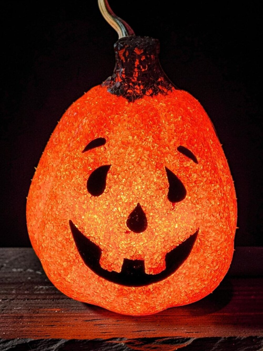 Vintage "Seasons" brand jack-o'-lantern is crafted from orange melted plastic po